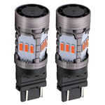 Two automotive light bulbs with a white background