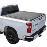 White Chevrolet Silverado truck with a syneticusa tonneau cover on a white background