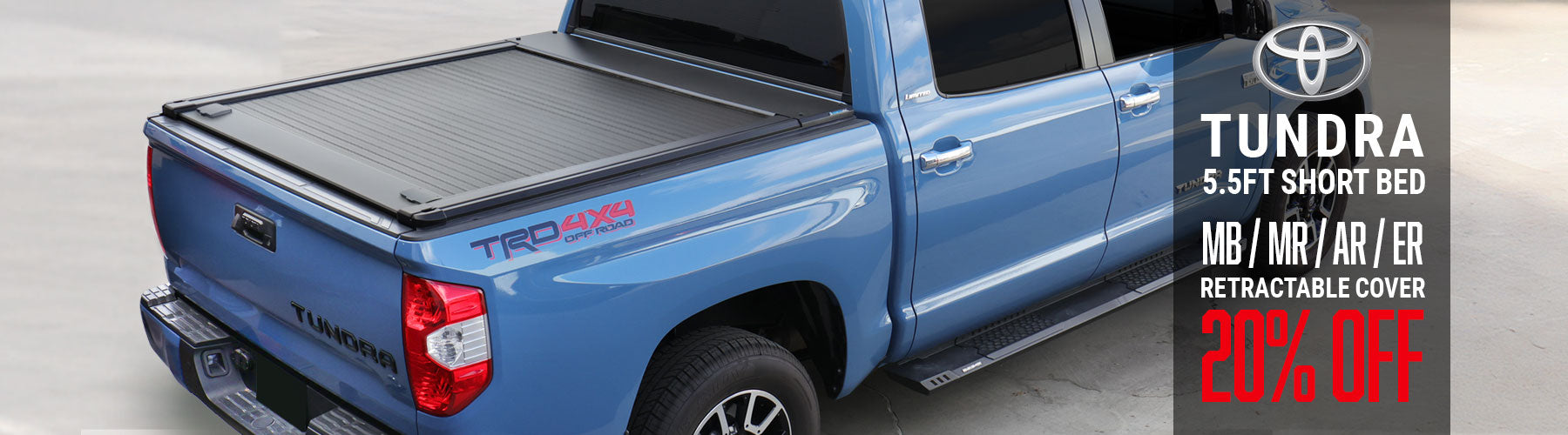 Blue Toyota Tundra truck with a retractable cover on a gray background