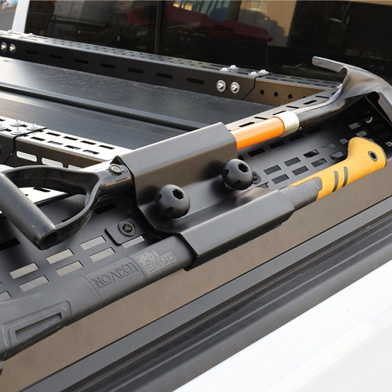 Tool organizer with a hammer and other tools on a reflective surface