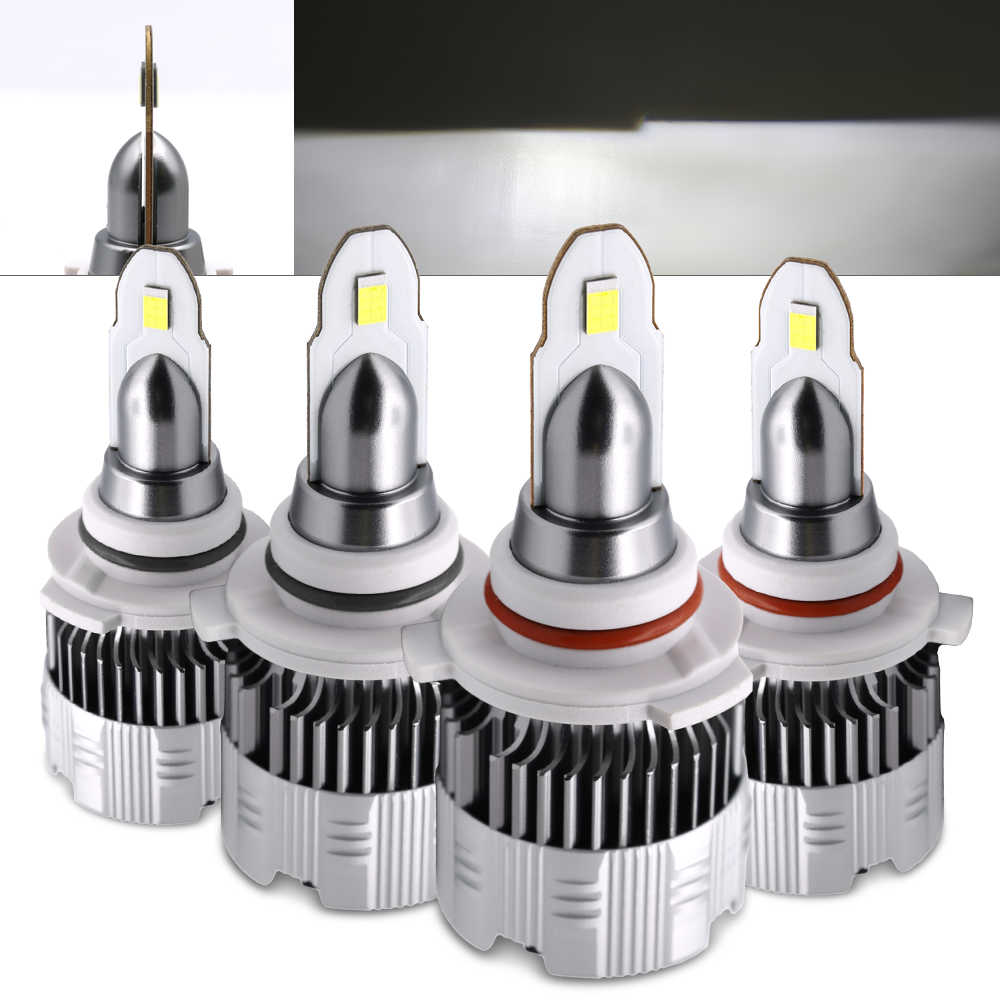 Four car headlight bulbs with metallic and white design on a white background