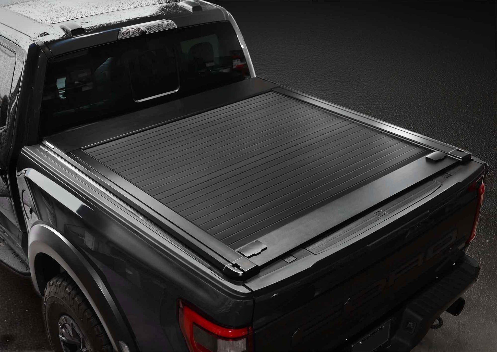syneticusa premium edition stealth black series tonneau cover installed on black f-150 raptor