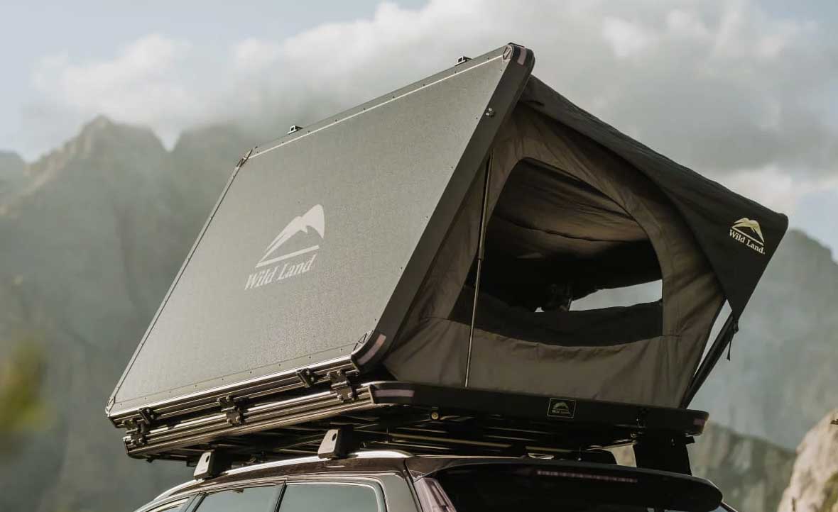 Roof top tent on a vehicle with mountains in the background