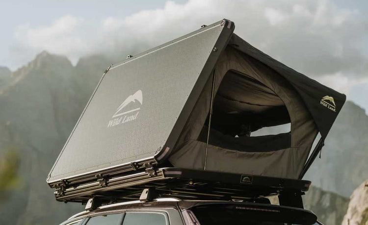Roof top tent on a vehicle with mountains in the background