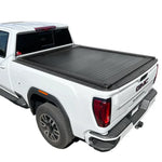 A black syneticusa retractable tonneau cover installed on a white GMC Sierra pickup truck with a 6.8ft bed.