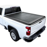 A black retractable tonneau cover installed on a white Chevrolet Silverado pickup truck.