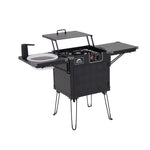 Black camping stove with cooktop and storage compartments on a white background