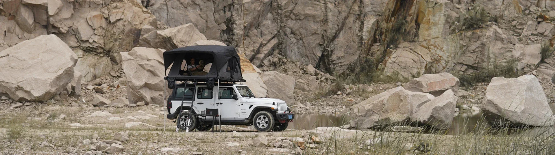 roof top tent installed on jeep parked by canyon environment