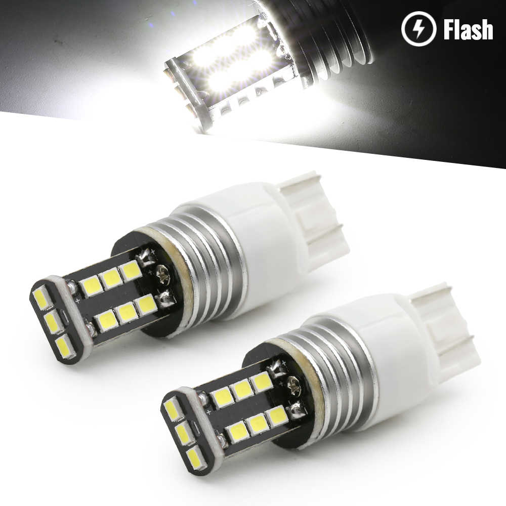 Two 7443 LED bulbs with a close-up of one showing light emission on a white background.