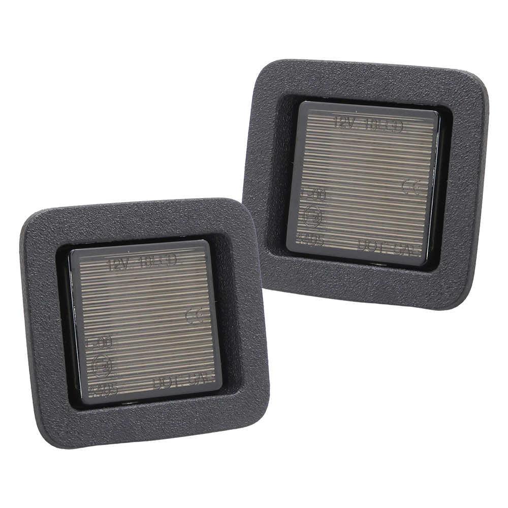 Two square license plate light with metallic grating inside on a white background