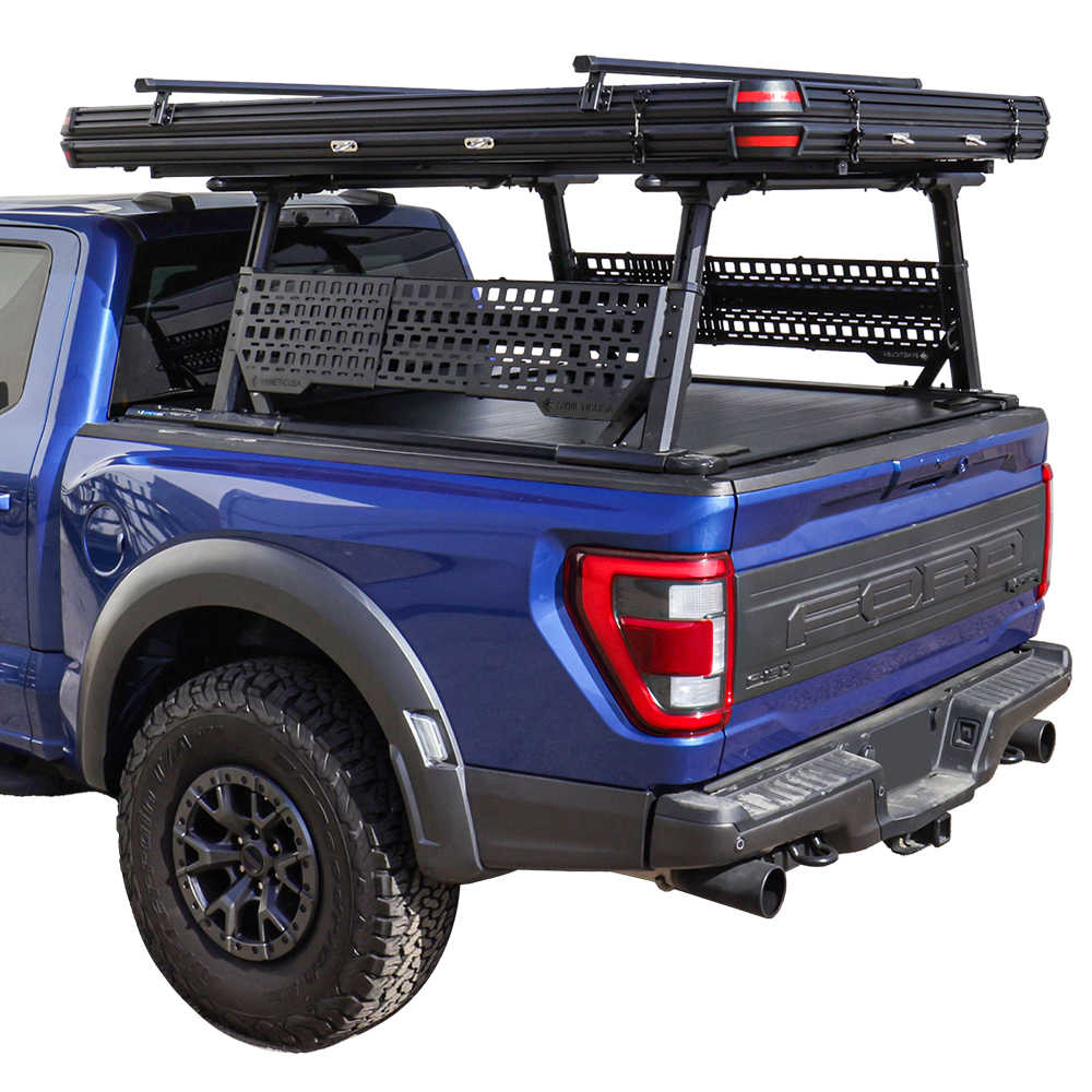 Blue Ford truck with a roof rack and cargo bed cover on a white background