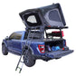Blue F150 with an open desert cruiser rooftop tent and ladder on a white background