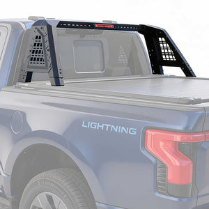 Back of a F-150 Lightning truck with a bed cover and roll bar installed on a white background