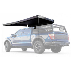 Black truck bed side awning cover on a blue pickup truck with a white background