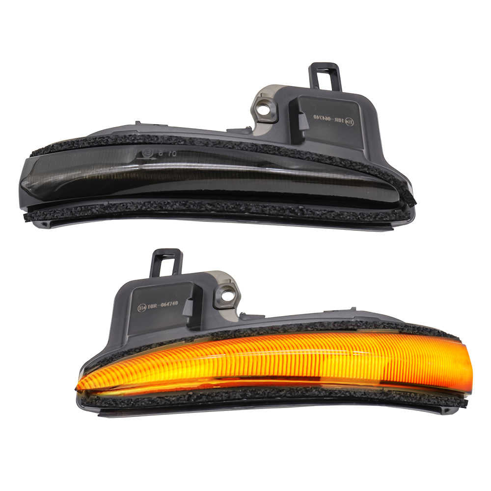Two side marker lights, one with a black casing and the other with an orange reflector, on a white background.