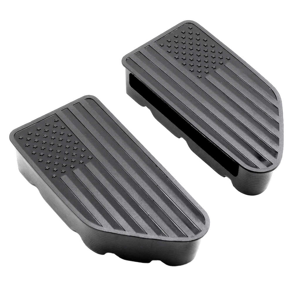A pair of black rubber vehicle step plates featuring an American flag design, with a raised star field in the upper left and diagonal stripes, shown on a plain white background.
