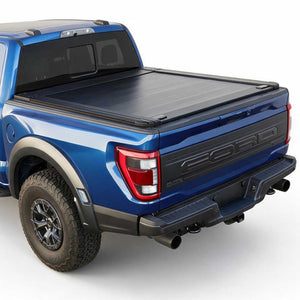 A black tonneau cover installed on the bed of a blue Ford pickup truck, shown from a rear three-quarter angle against a clean white background.