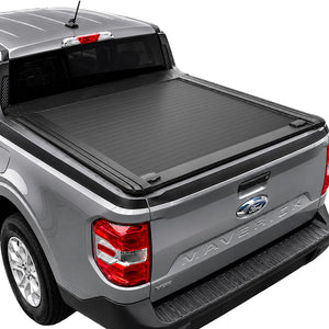 A black roll-up truck bed cover installed on the bed of a gray Ford Maverick pickup truck, shown from a rear three-quarter angle against a white background.