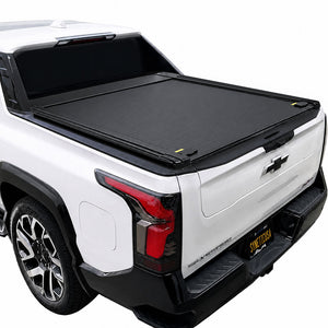 A double t-slot retractable bed cover installed on the bed of a white pickup truck, shown from a rear three-quarter angle against a plain white background.