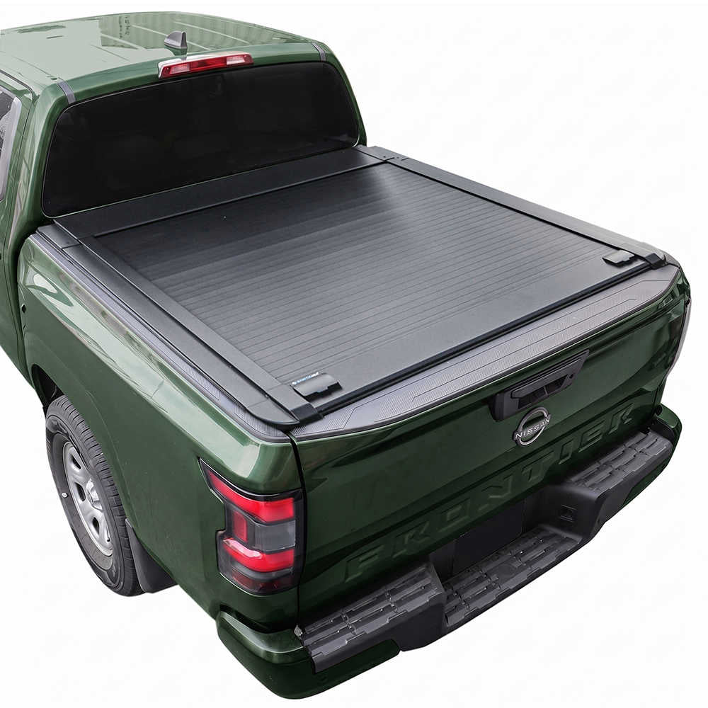 A black Frontier 6ft truck bed cover installed on the bed of a dark green pickup truck, shown from a rear three-quarter angle against a plain white background.