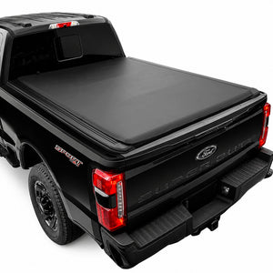 A black soft roll-up tonneau cover installed on the bed of a black Ford F-250 pickup truck, shown from a rear three-quarter angle against a white background.