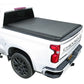 White Chevrolet truck with a gray soft roll up tonneau cover on a white background