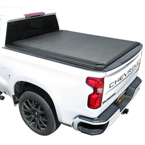 White Chevrolet truck with a gray soft roll up tonneau cover on a white background