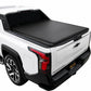 A black tonneau cover installed over the bed of a white Silverado EV truck, shown from a rear three-quarter angle against a plain white background.
