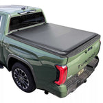 Green Toyota Tundra truck with a soft roll-up tonneau cover on a white background