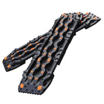 Black and orange snowmobile tracks on a white background
