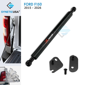 A black SYNETICUSA tailgate assist shock strut designed for Ford F-150 models from 2015 to 2026, displayed alongside necessary parts for installation.