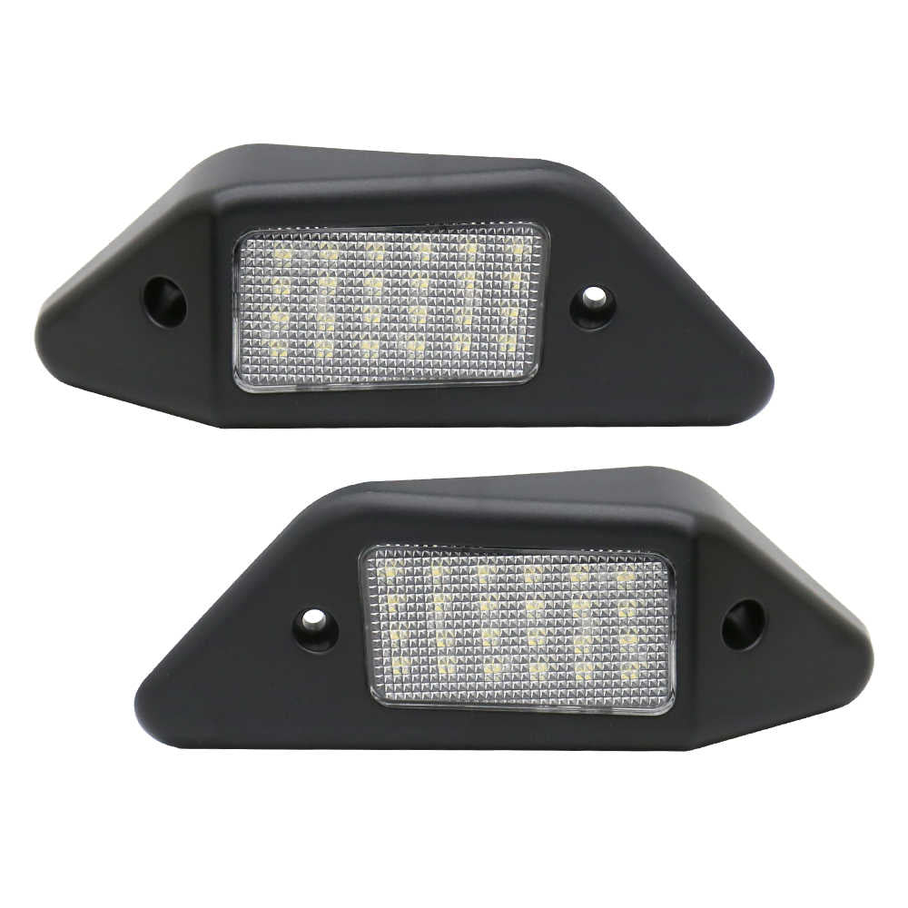 Two black LED license plate lights on a white background