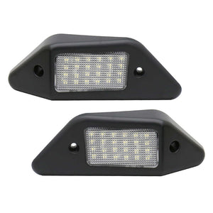 Two black LED license plate lights on a white background