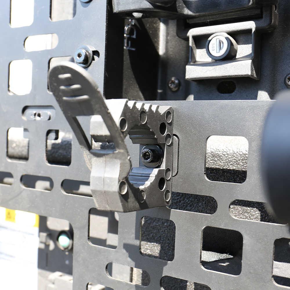 Close-up of a metal bracket with screws and a textured surface