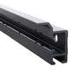A close-up of a black metal linear guide rail with a silver top plate, showing its profile and mounting holes against a white background.