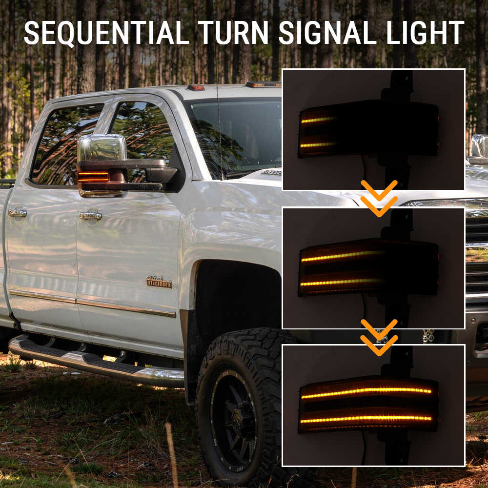 White truck with sequential turn signal light on side mirror, shown in dark setting.