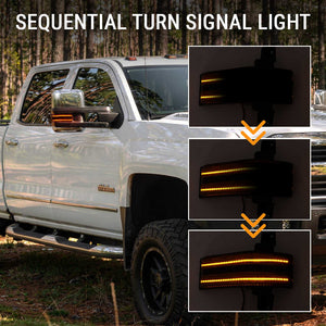 White truck with sequential turn signal light on side mirror, shown in dark setting.