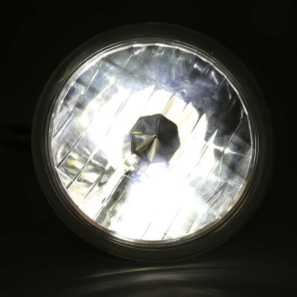 Round headlight with reflective surface on a black background
