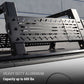 Black aluminum truck bed rack mounted over the bed of a dark pickup truck, with text overlay reading 'HEAVY DUTY ALUMINUM Capacity up to 600 lbs'.