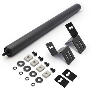Set of components including a large black roller and various smaller parts on a white background