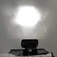 Black motorcycle seat with a reflective surface against a gray background