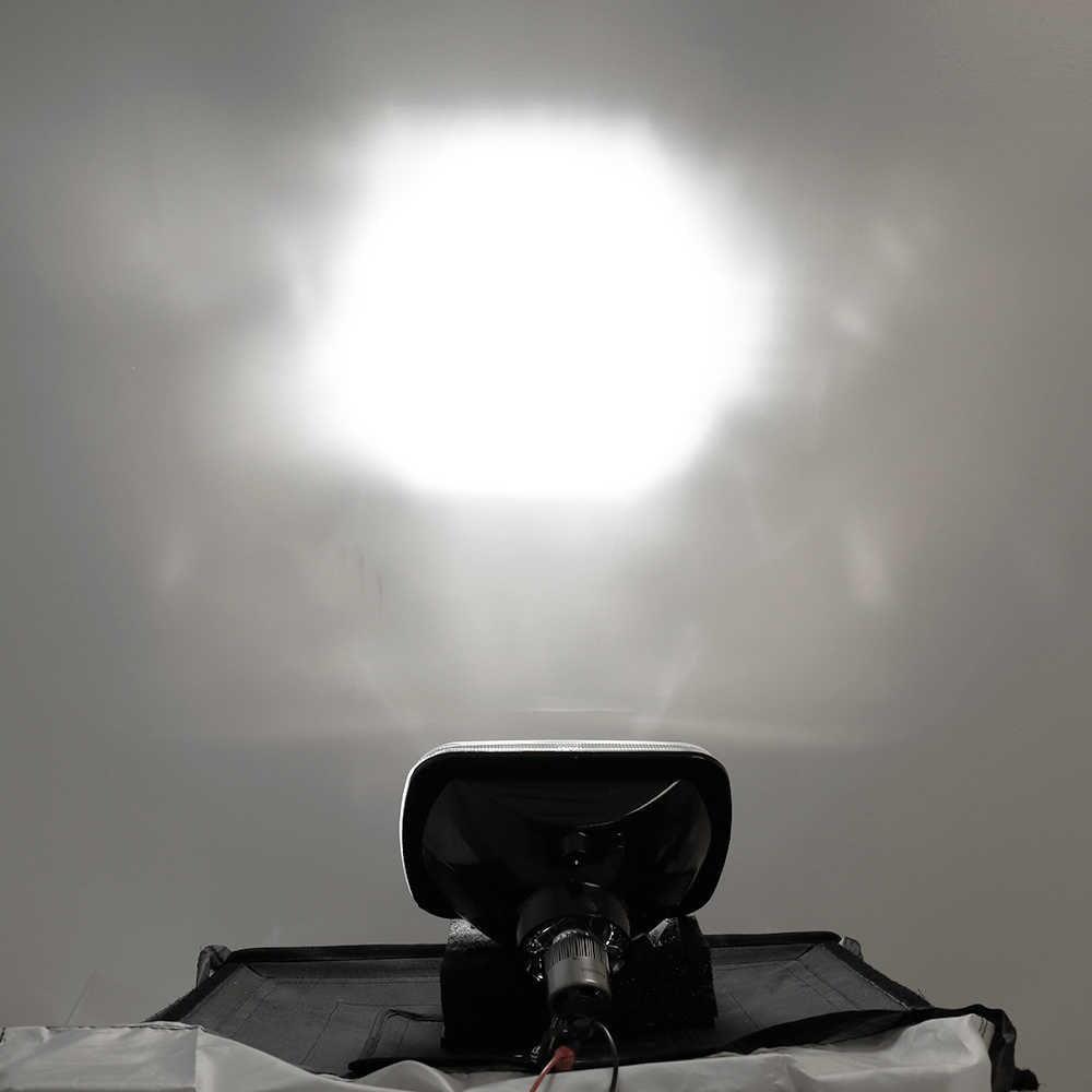 Black motorcycle seat with a reflective surface against a gray background
