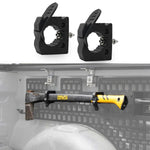 Two black plastic mounting brackets shown above, with a shotgun mounted on the inside of a vehicle tailgate below against a gray background.