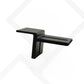 A matte black metal wall-mount shelf bracket with a horizontal shelf and a vertical mounting stem, shown against a white background with a faint gray geometric pattern.