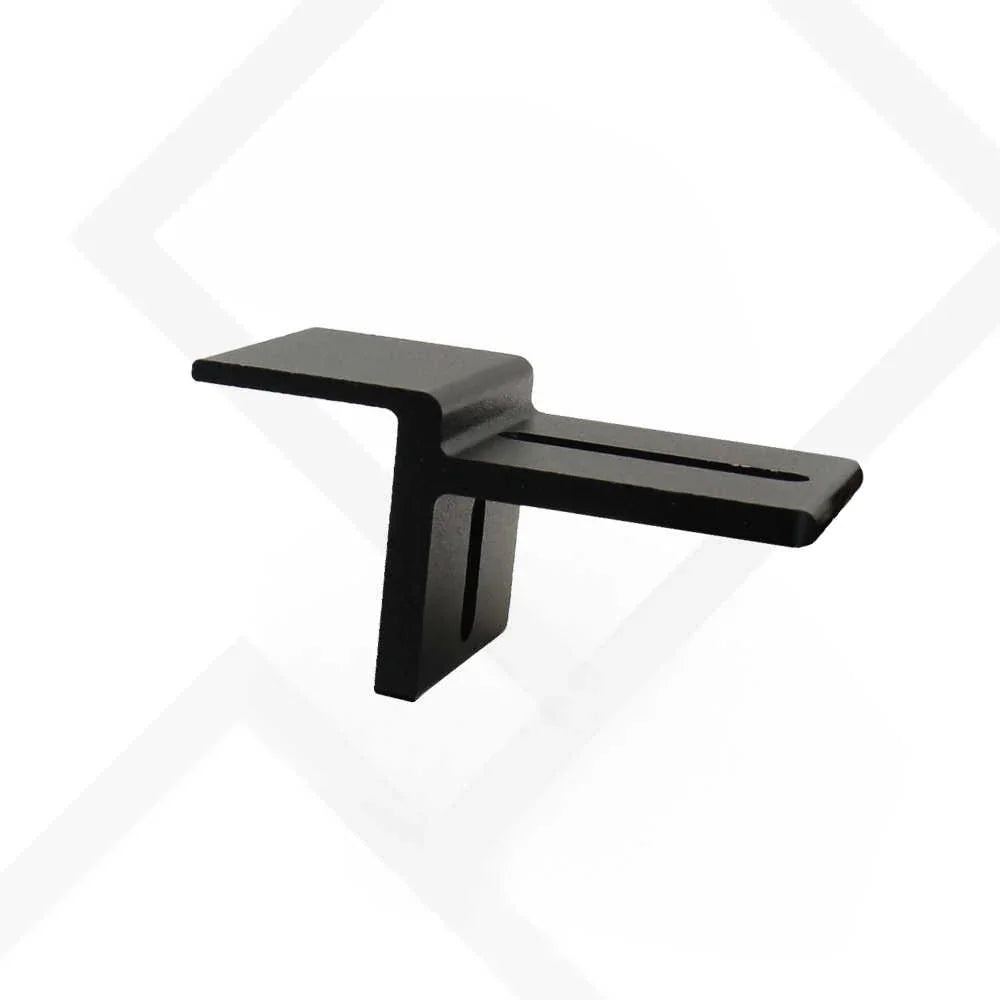 A matte black metal wall-mount shelf bracket with a horizontal shelf and a vertical mounting stem, shown against a white background with a faint gray geometric pattern.