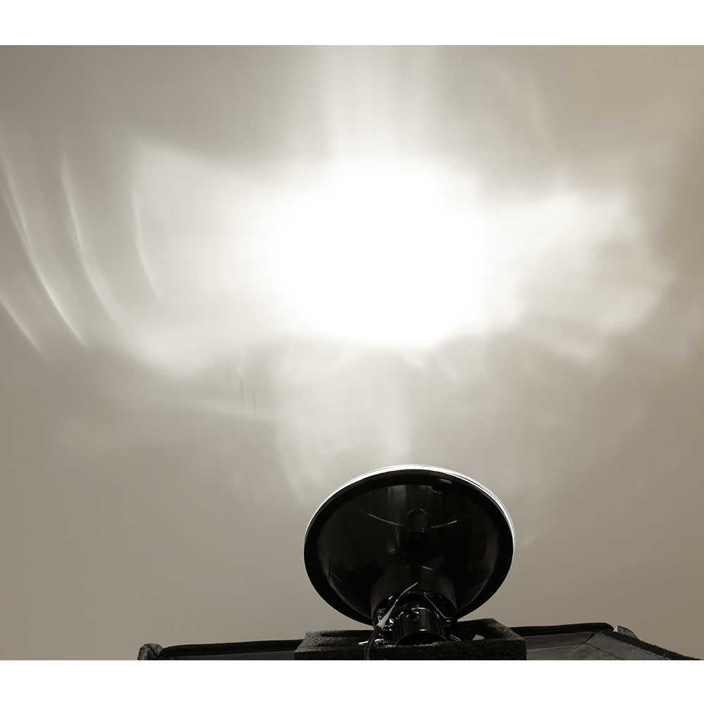 Close-up of a car headlight with a white background