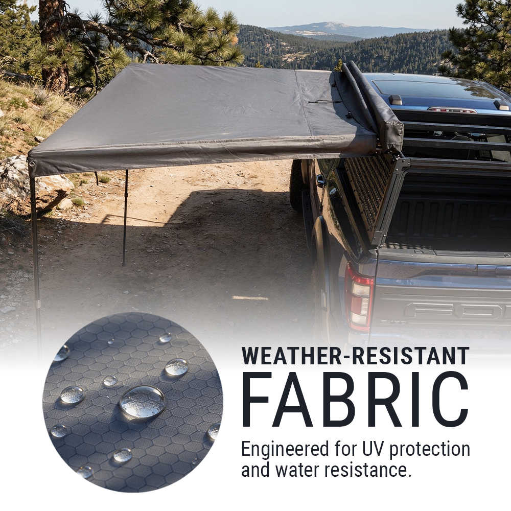 Weather-resistant fabric cover on a truck bed with mountainous background