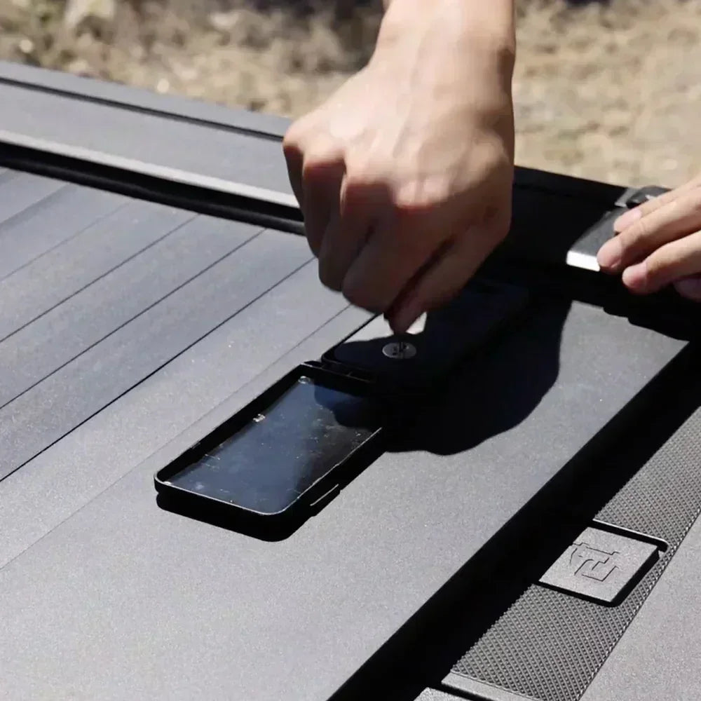 Person unlocks retractable tonneau cover