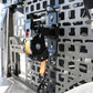 Close-up of a mechanical device attached to a textured metal surface