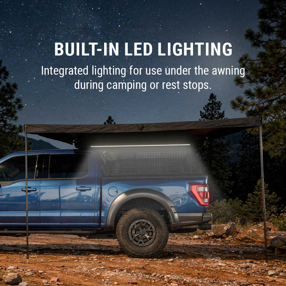 Blue truck with an awning and built-in LED lighting system under a starry night sky.